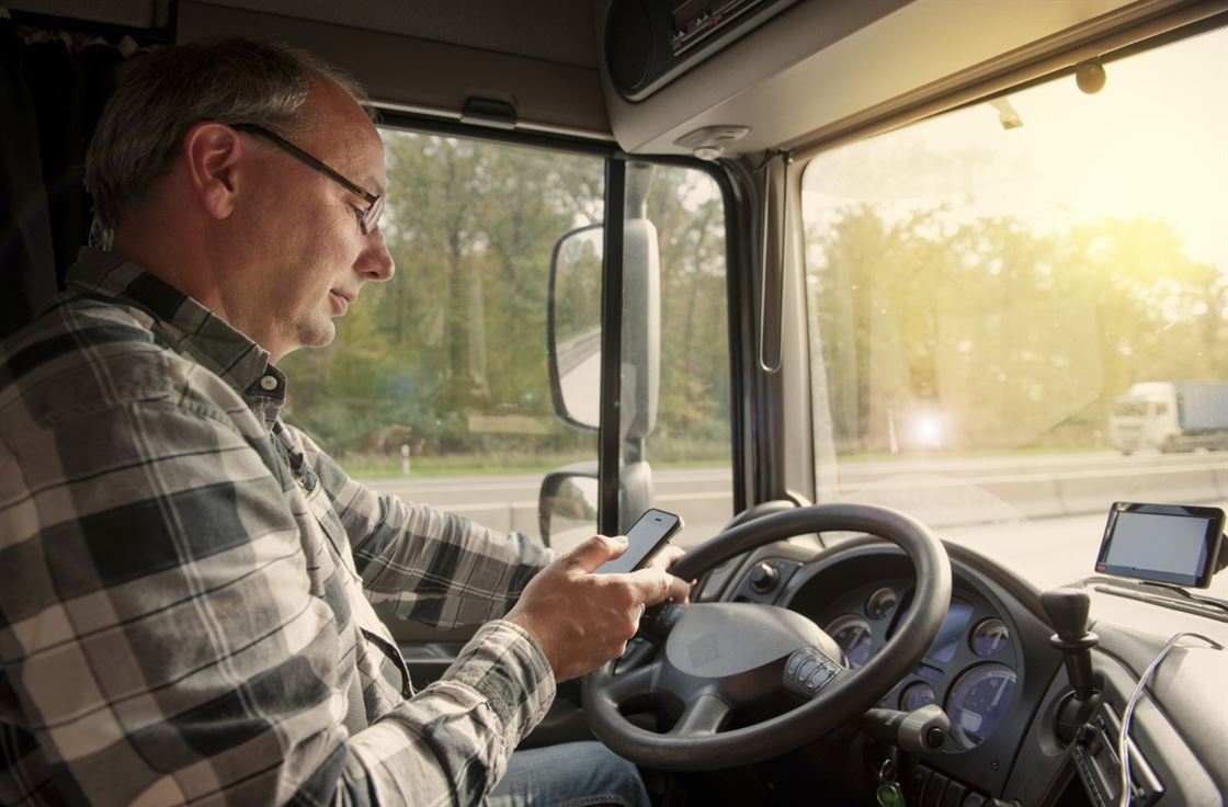 A person driving a truck using a phone

AI-generated content may be incorrect.